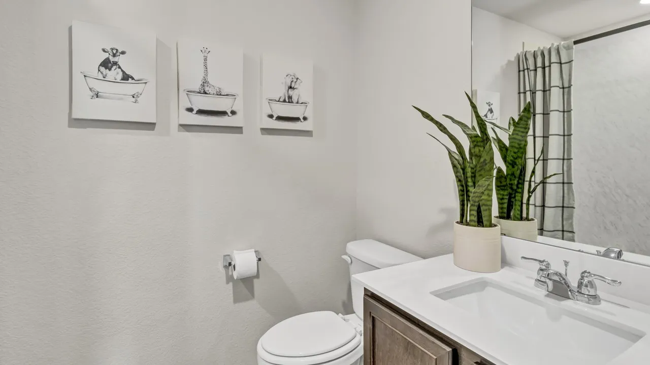 Bathroom vanity with a white countertop and integrated sink, chrome faucet, and dark wood-finish cabinetry