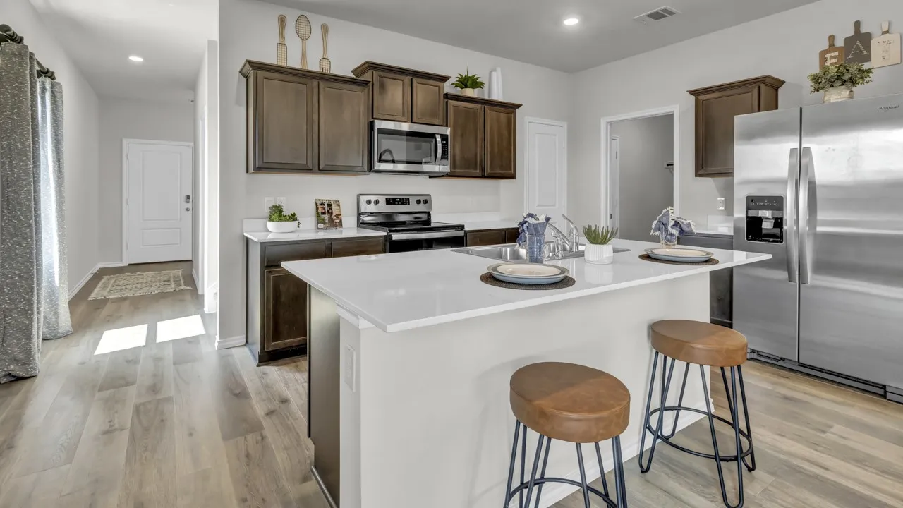 Open-concept kitchen with a central island featuring a white countertop