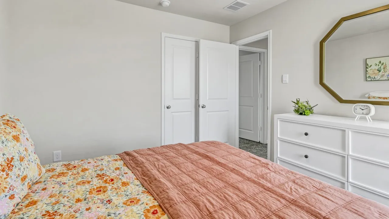 Bedroom featuring light gray walls, white trim, and gray carpet