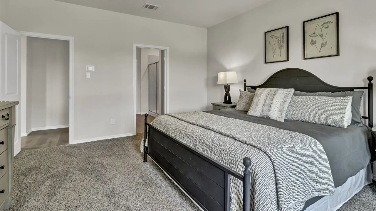 Carpeted bedroom featuring light-toned walls and white trim