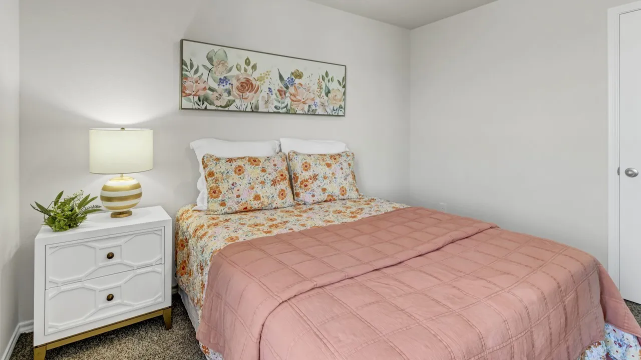Bedroom featuring light-colored walls and soft carpet flooring