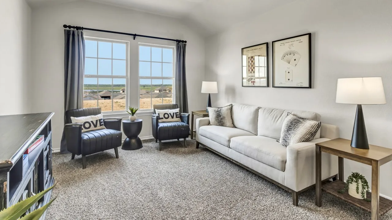 Spacious room featuring vaulted ceilings, two large windows with grid patterns, light-toned carpeting, and neutral wall finishes