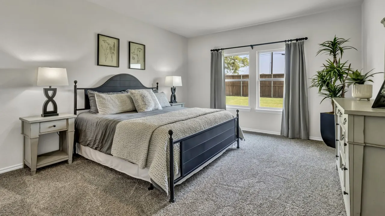 Spacious room featuring neutral carpeting and white walls