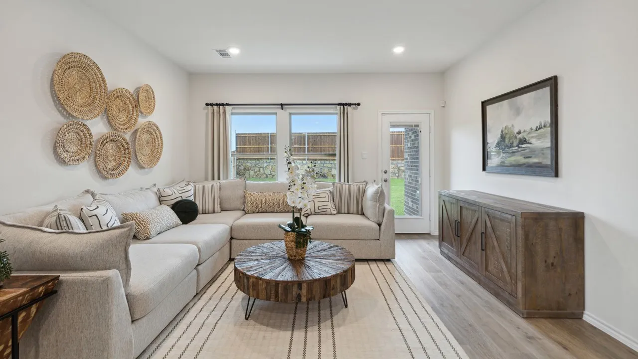 Open-concept living space featuring wood-finish flooring, recessed lighting, and ample natural light from multiple windows