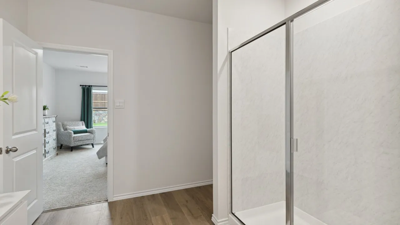 Shower enclosure with clear glass doors and a white base