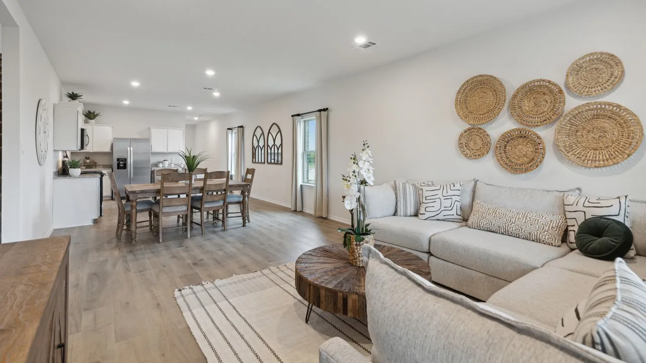 Open-concept living space featuring wood-finish flooring, recessed lighting, and ample natural light from multiple windows