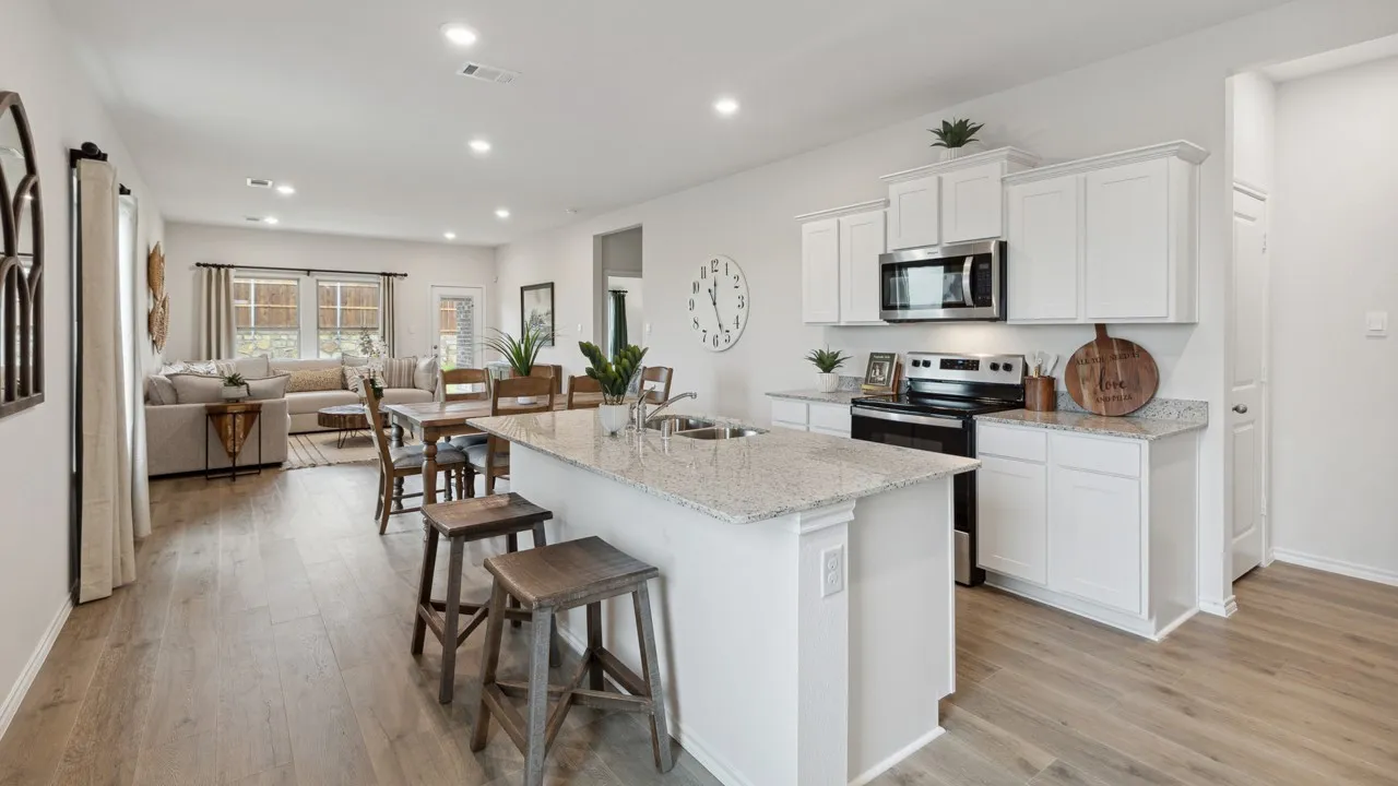 Open-concept living space featuring wood-finish flooring throughout