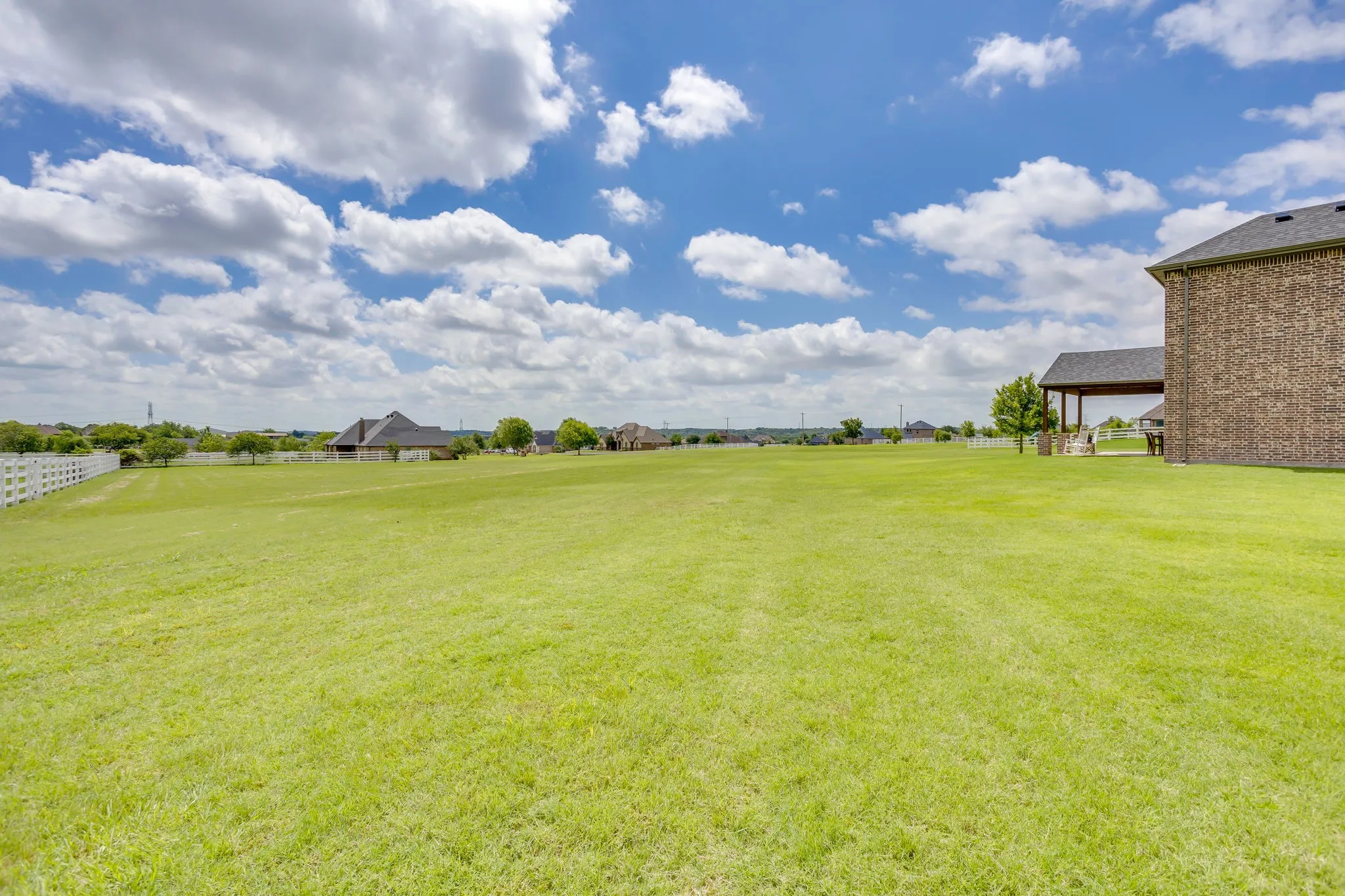 Yard to left of house and utility easement to left
