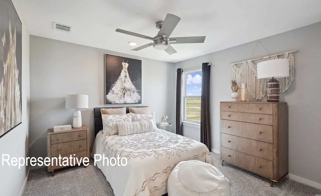 Carpeted room featuring a ceiling fan with integrated lighting, a window with dark drapes, and light gray walls