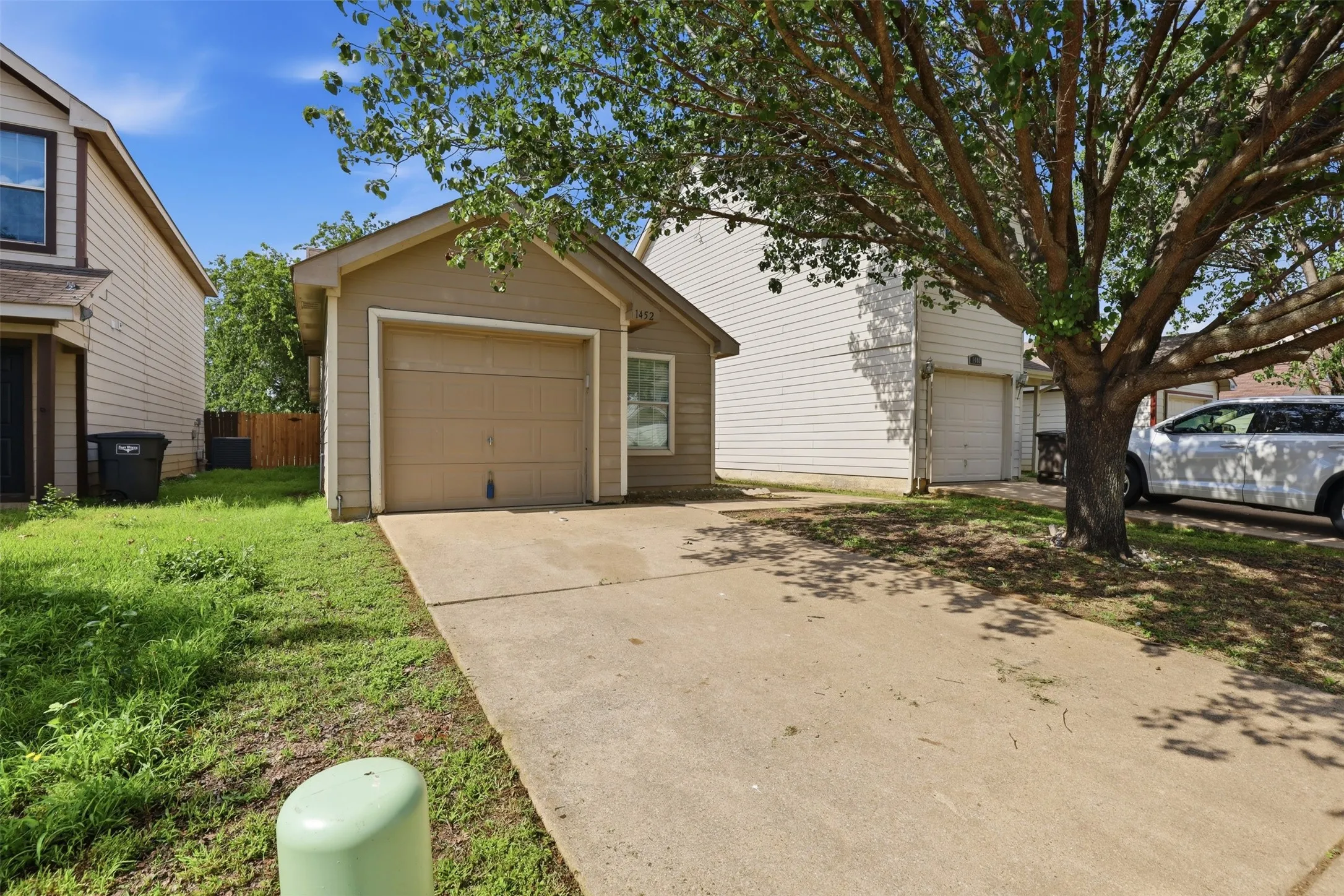 Single-car garage with a concrete driveway and an overhead door