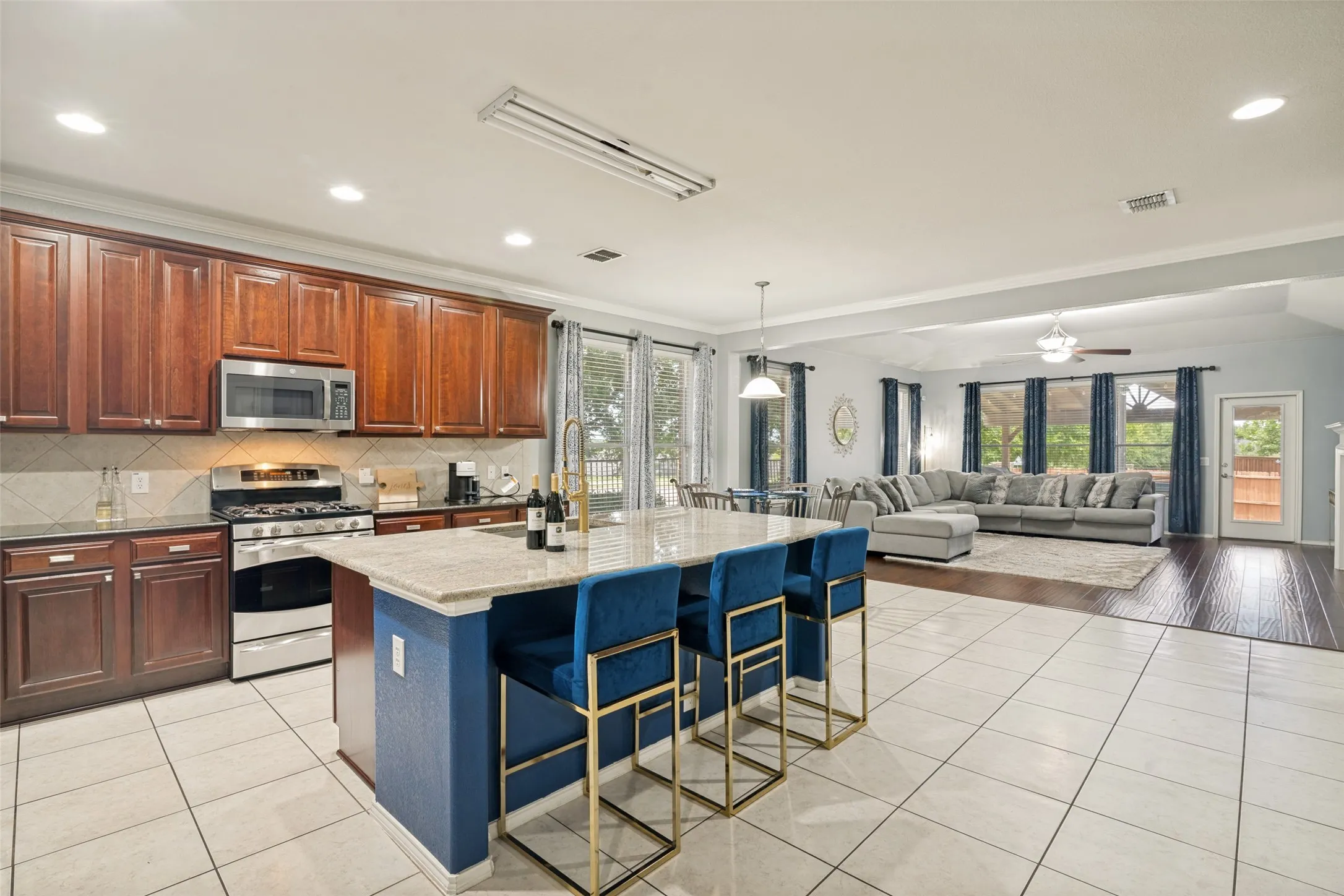 Open concept living with eat in kitchen. eating at the large island and tons of cabinet space for storage.