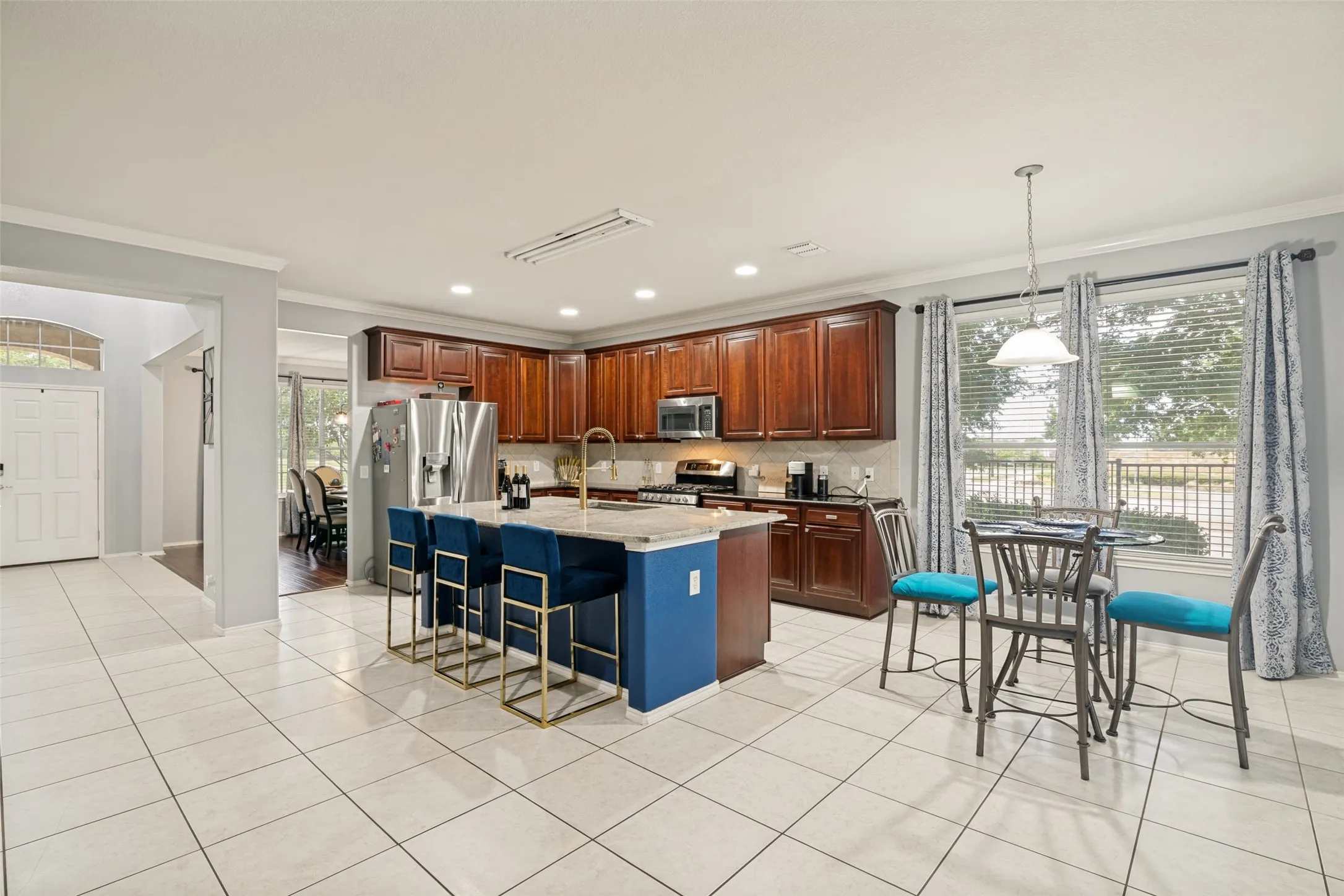 View of the kitchen, eat in dinging and views towards the front door and the dining room.