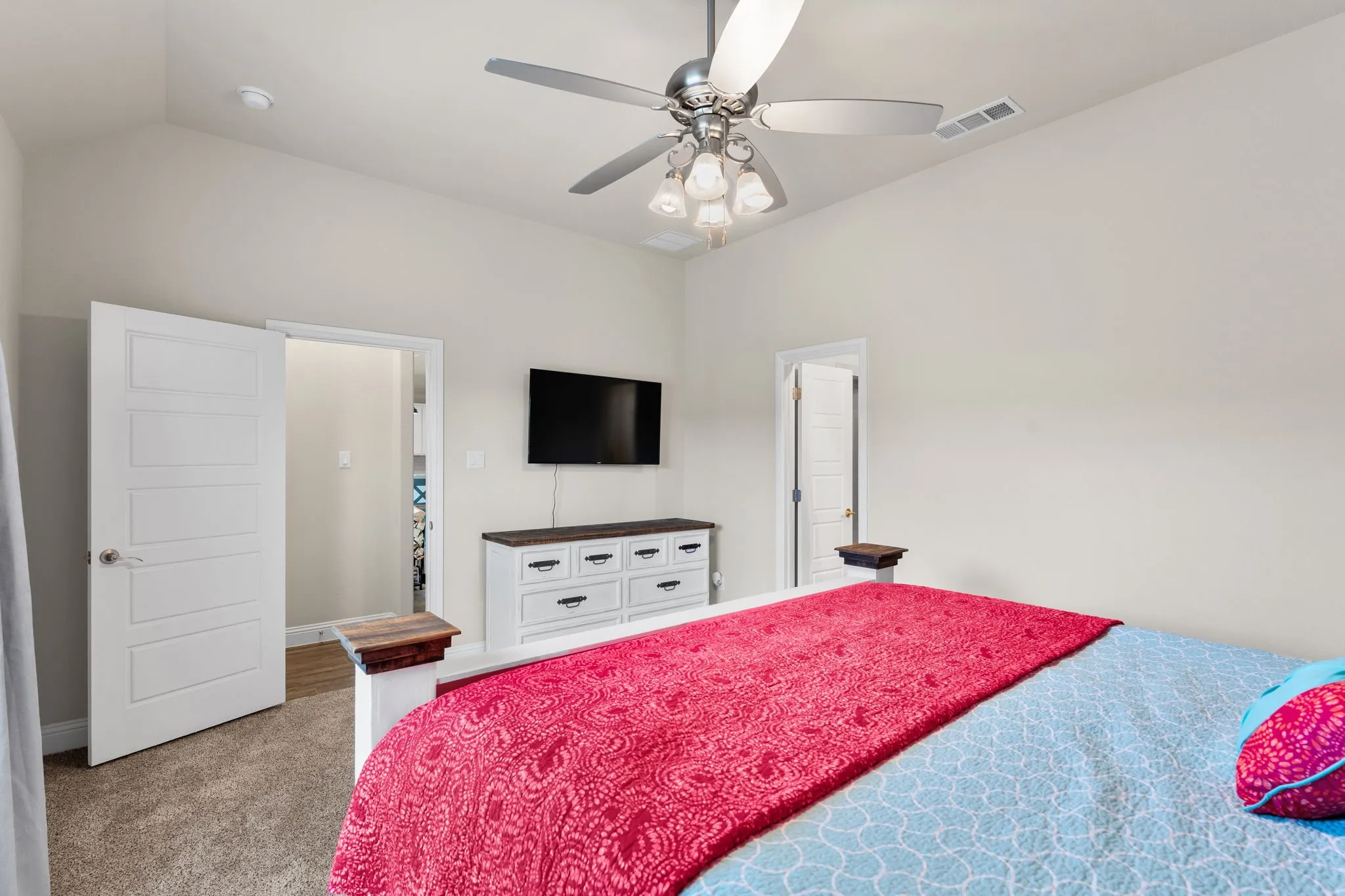 Master bedroom with ceiling fan, windows for natural lighting.