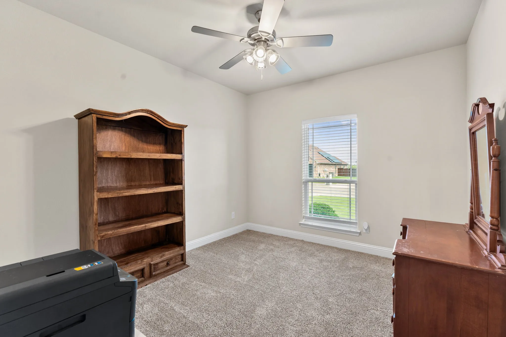 bedroom #3 with ceiling fan, carpet, window for natural lighting and a walk in closet.