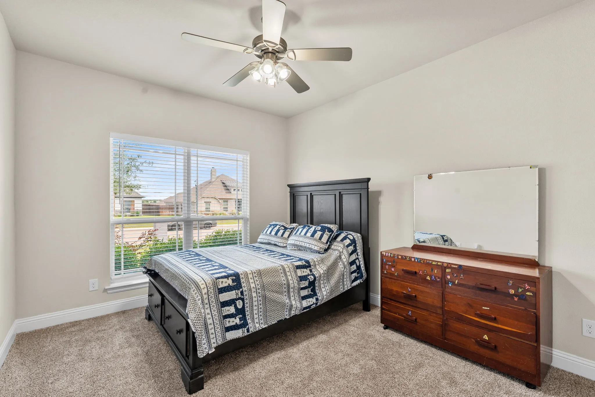 Bedroom #2 with ceiling fan, carpet, large windows for natural lighting and a walk in closet.