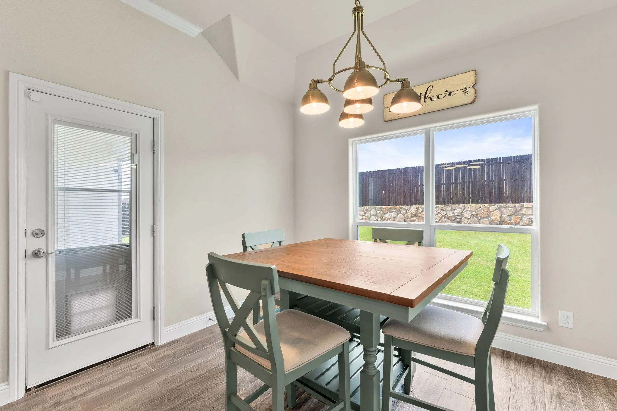 Large dining area with lighting, and windows for natural light.
