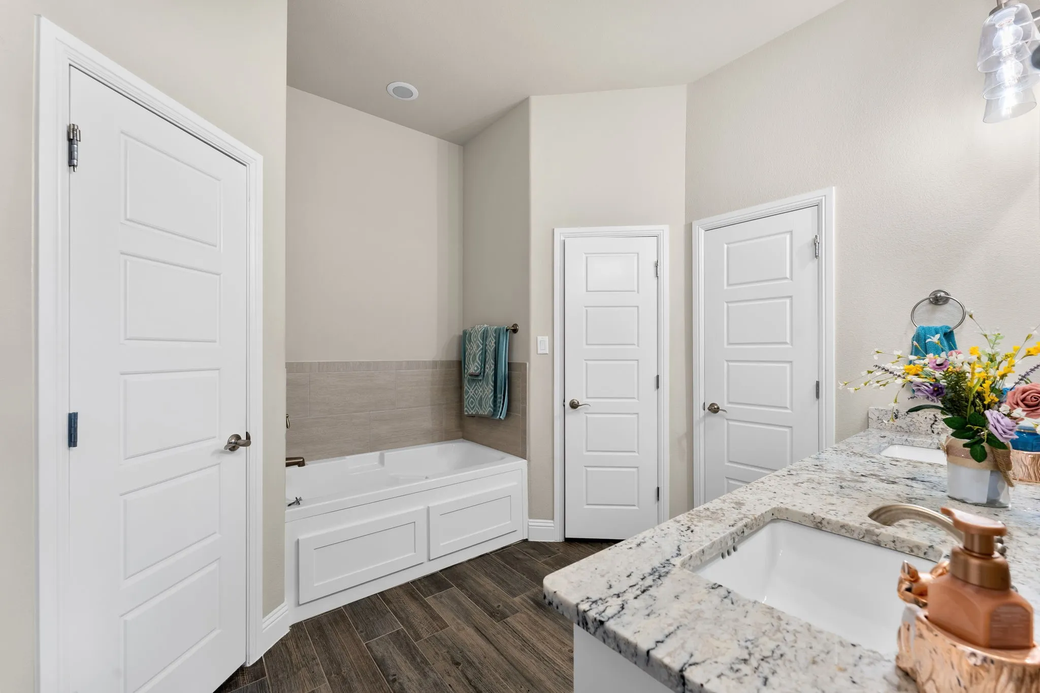 Master bathroom with his and hers walk in closets, large soaking tub, and a walk in shower with multiple soap trays.