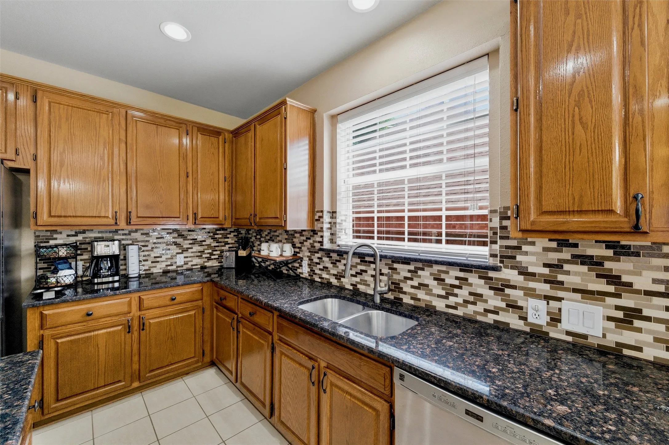 Stainless steel dishwasher, undermount sink and pull down faucet.