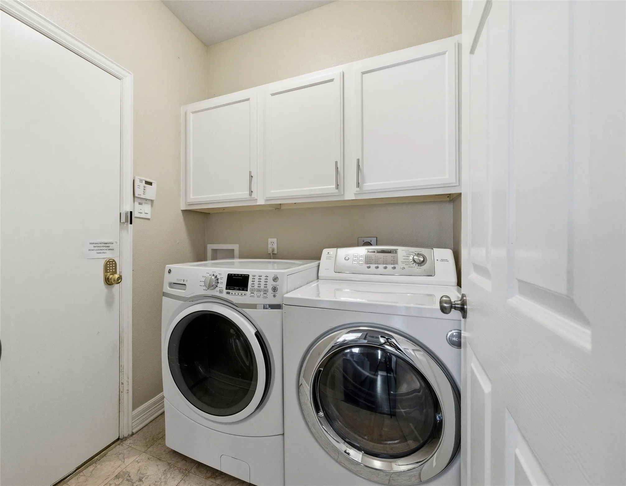 Utility Room has built in cabinets, door to garage to the left