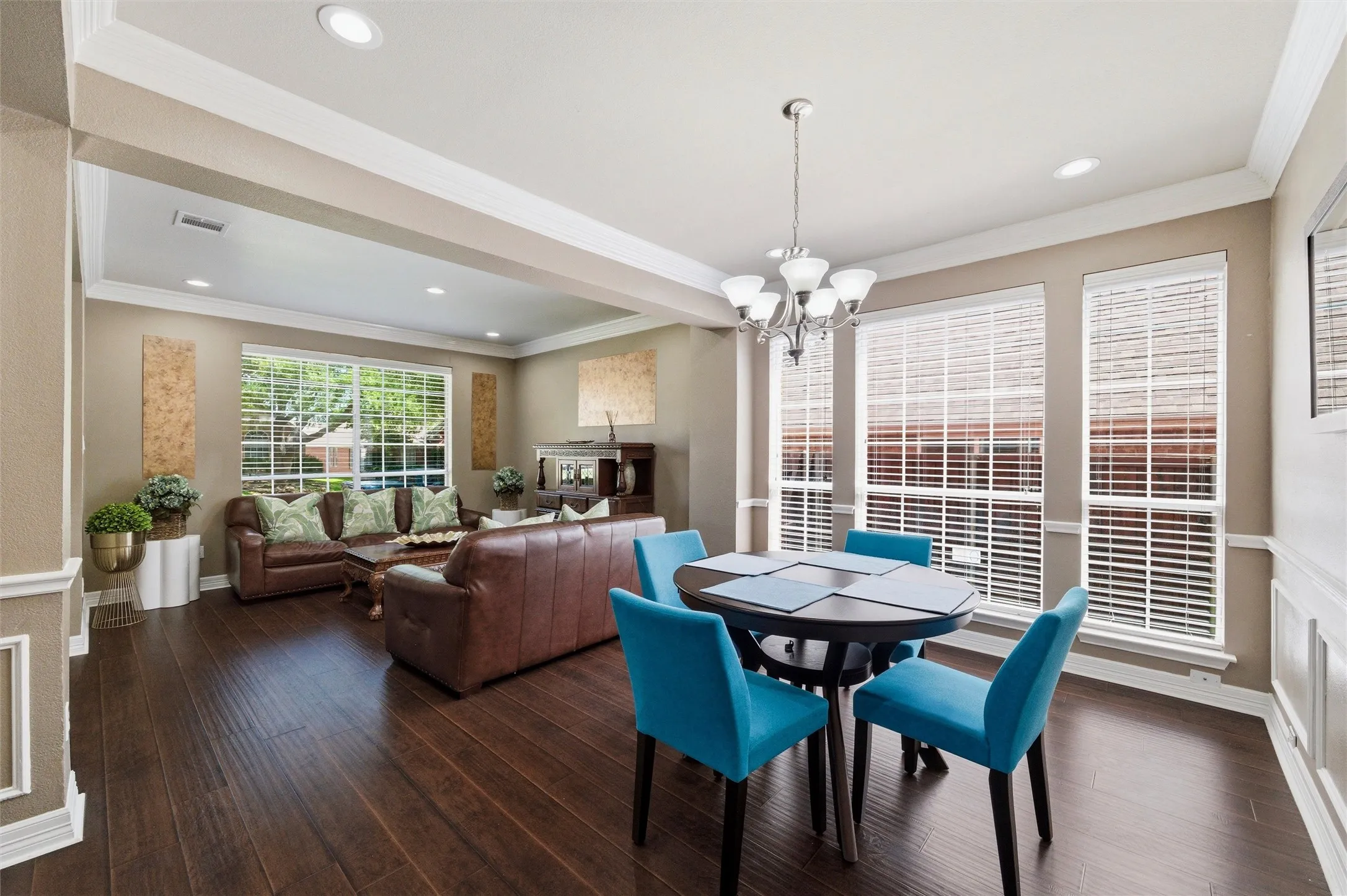 Light filled Dining Rm with chair rail and crown molding.