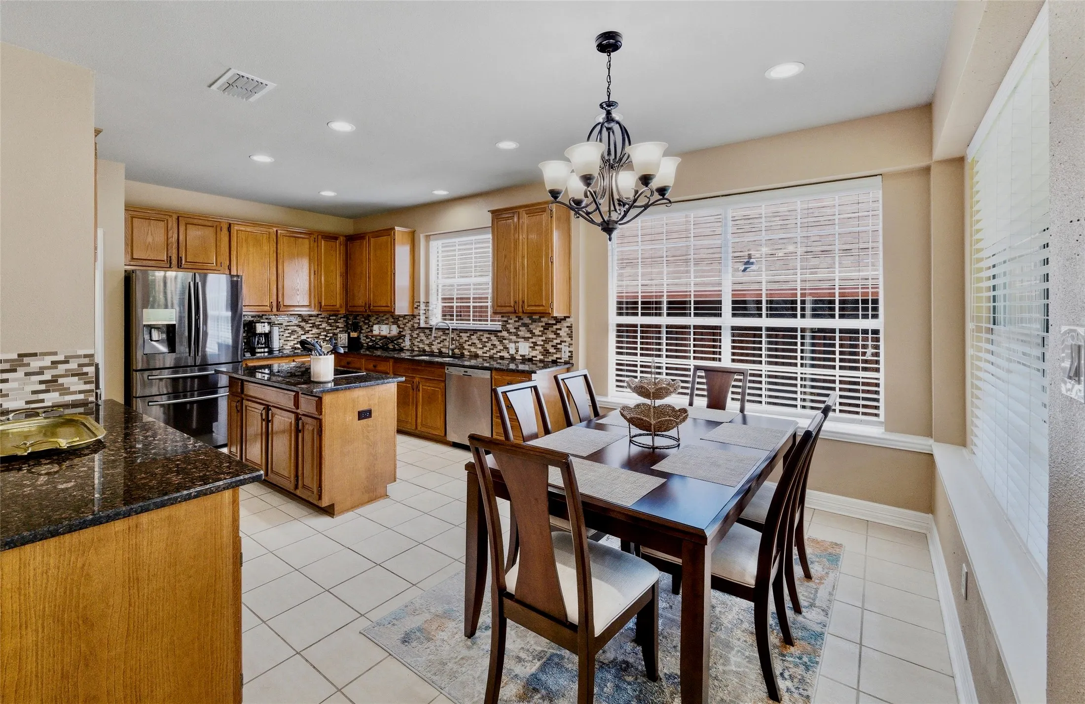 Large eat in kitchen with granite counters and quality glass mosaic backsplash. Lots of storage with 42in cabinets.