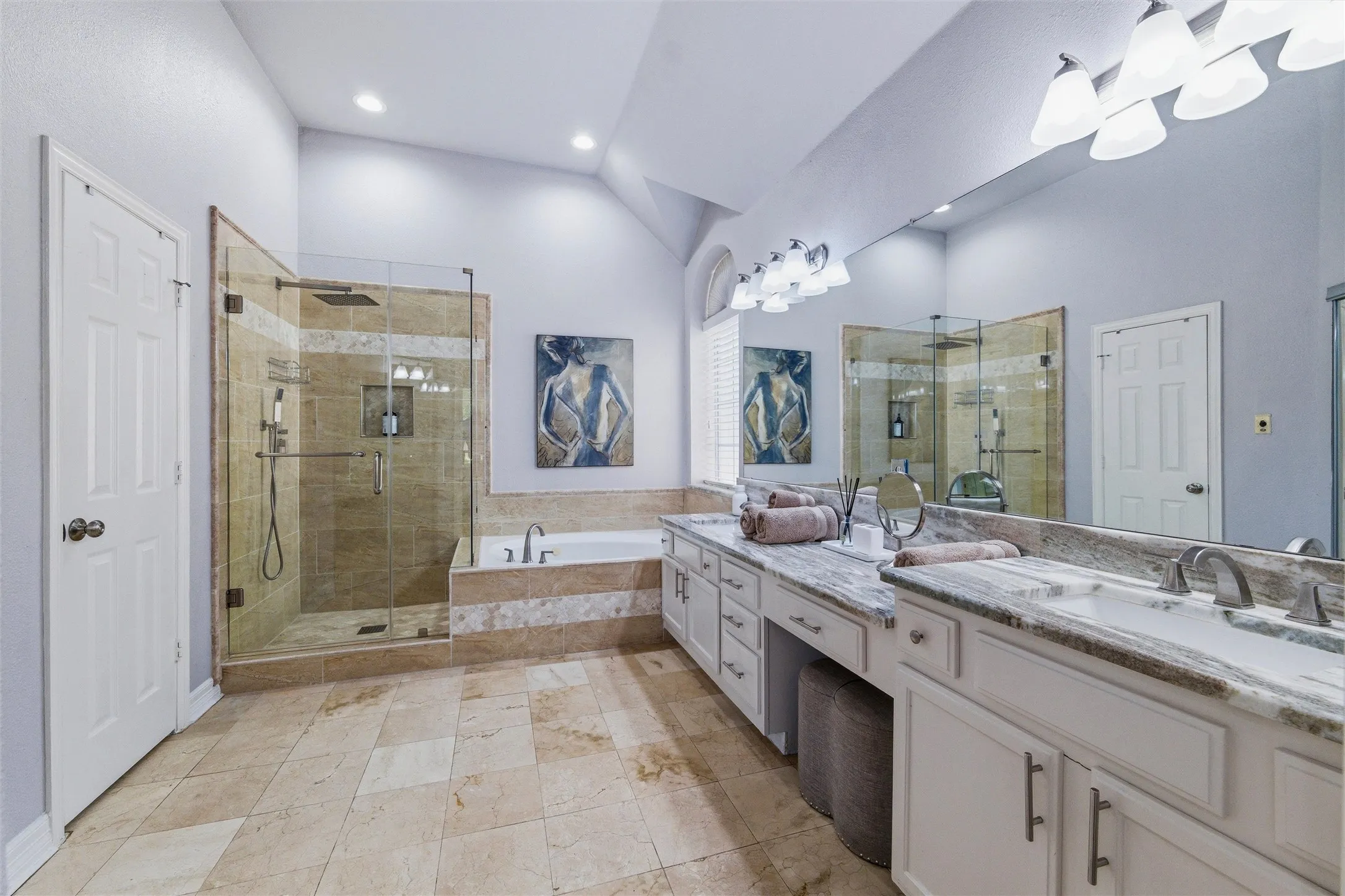 Updated ensuite bath features marble floors, shower surround, and counters, seamless glass, and bidet. Dual vanities, jetted tub, and all updated fixtures including rain head with handheld shower faucets.