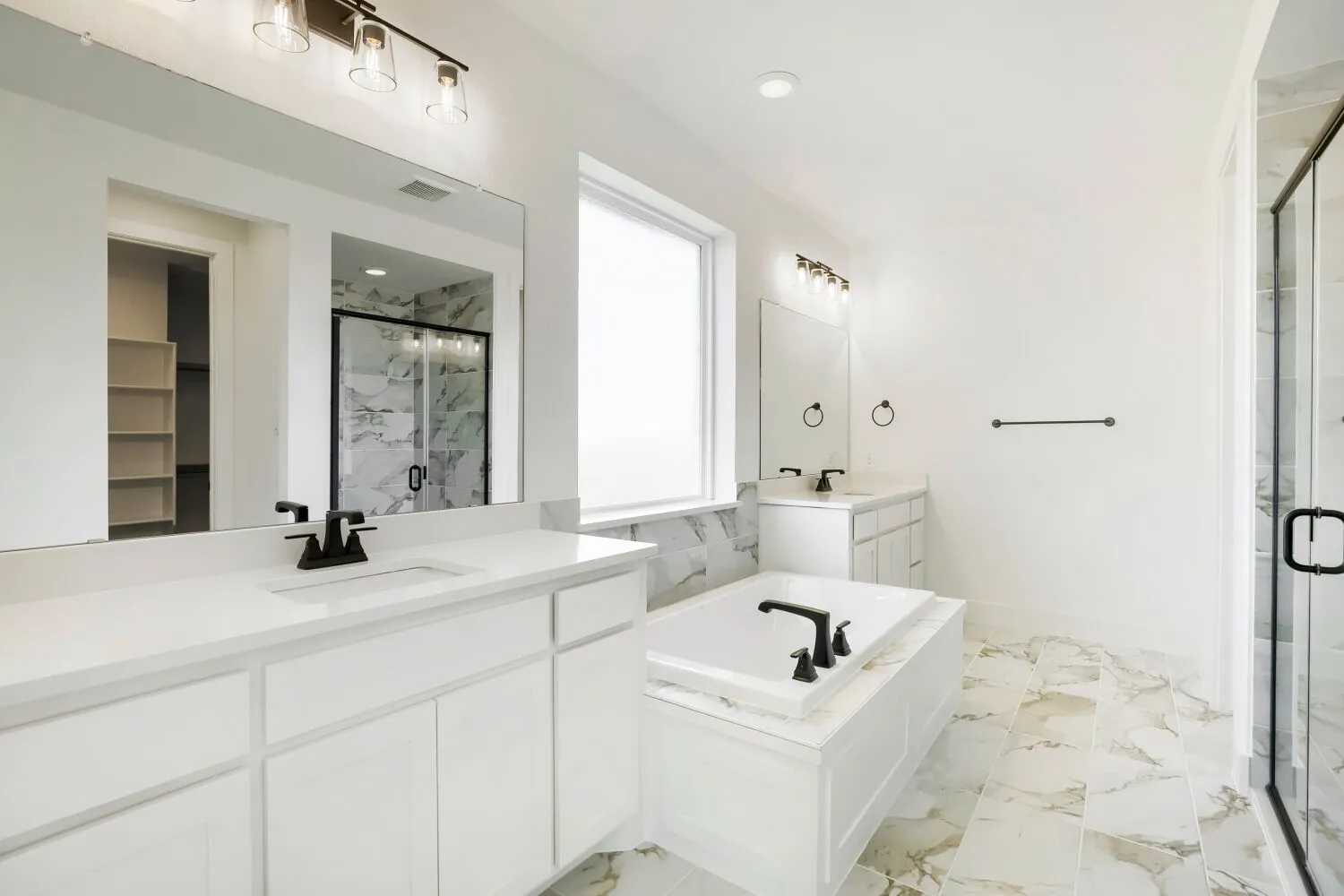 Dual vanities with white cabinetry and countertops