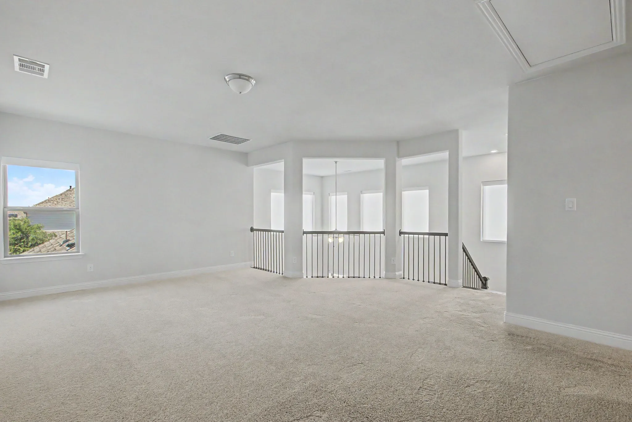 Expansive carpeted area with neutral walls