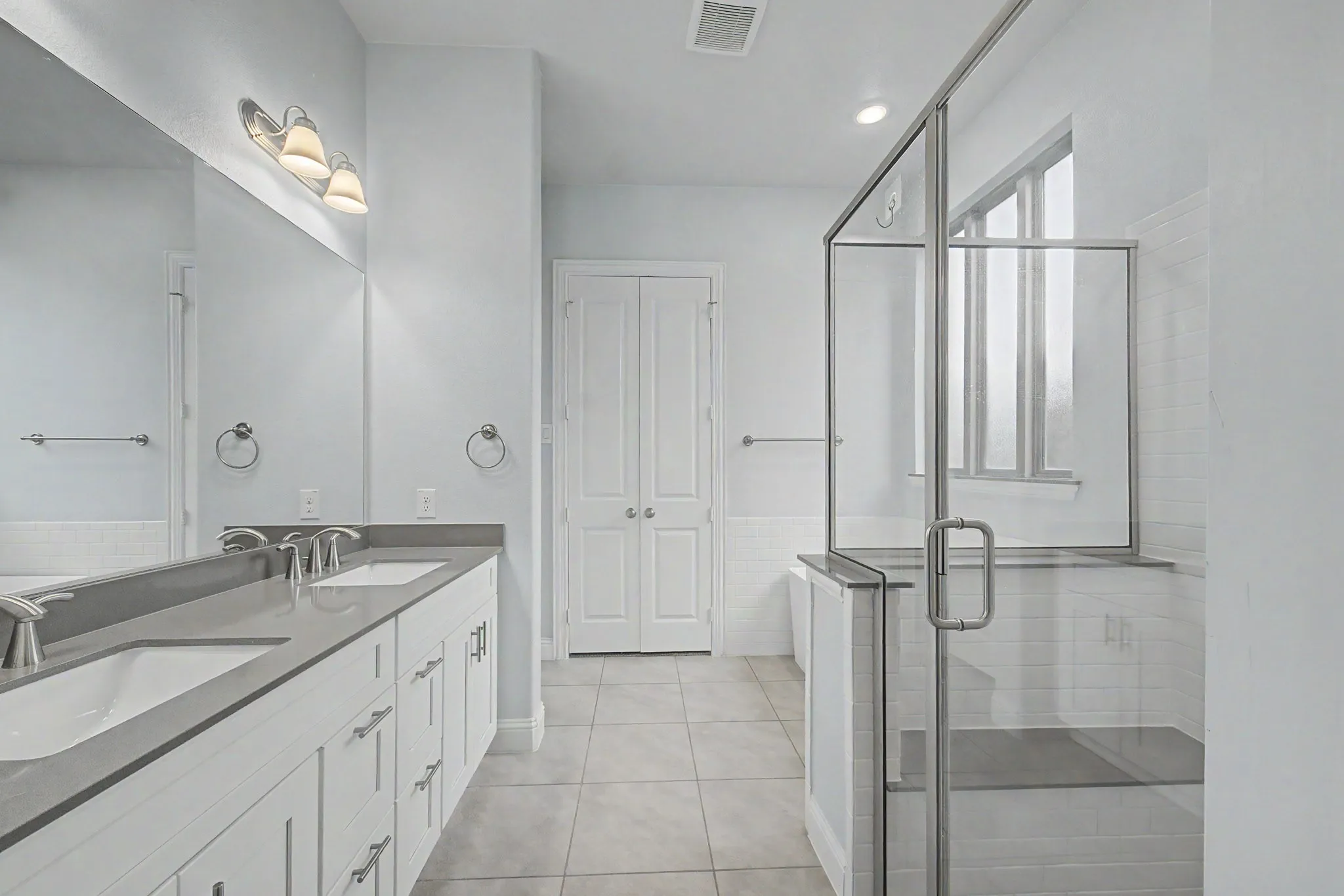 Double vanity with undermount sinks and grey countertop