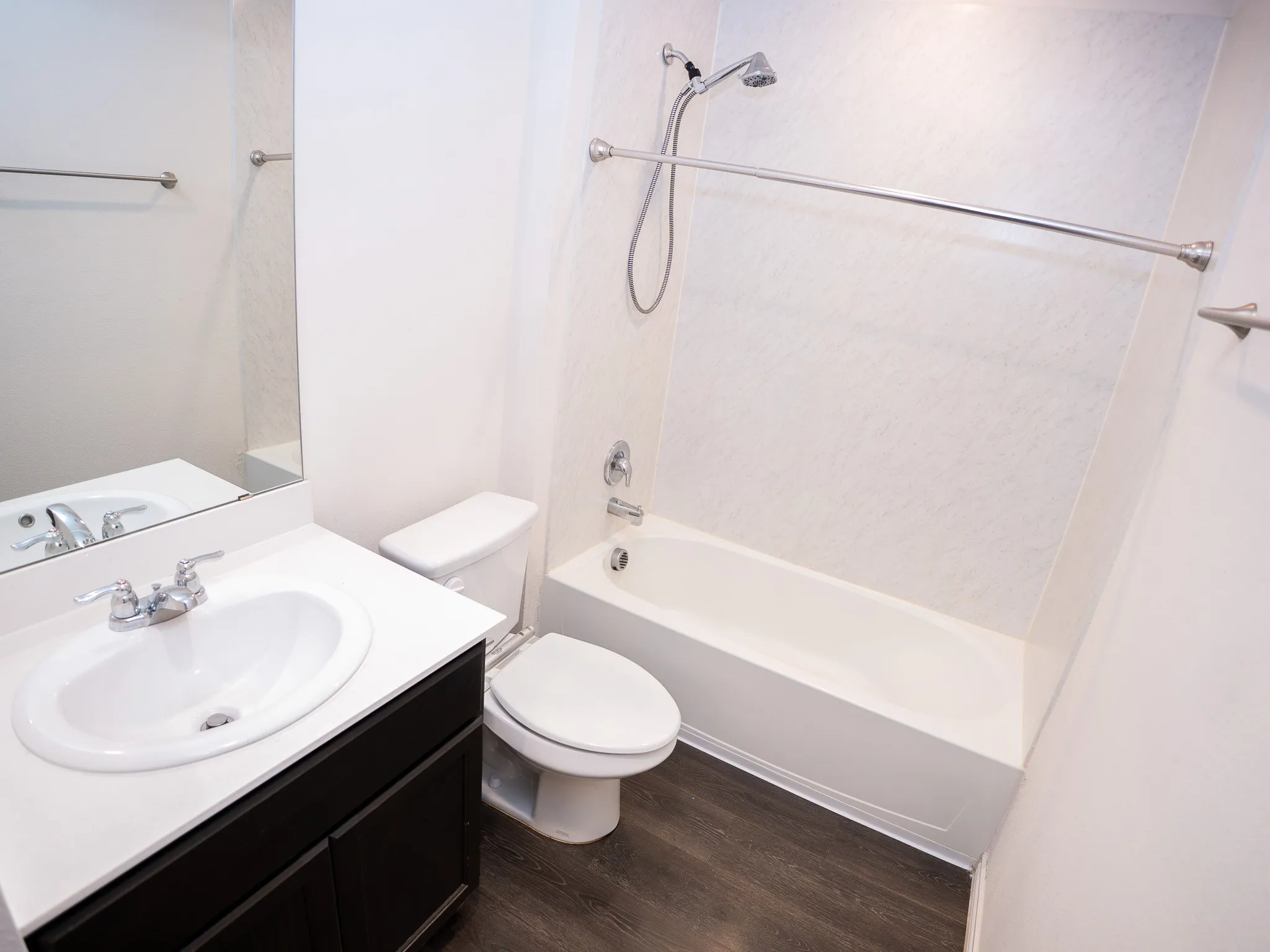 Bathroom 2 featuring a white bathtub and shower combination with a textured surround