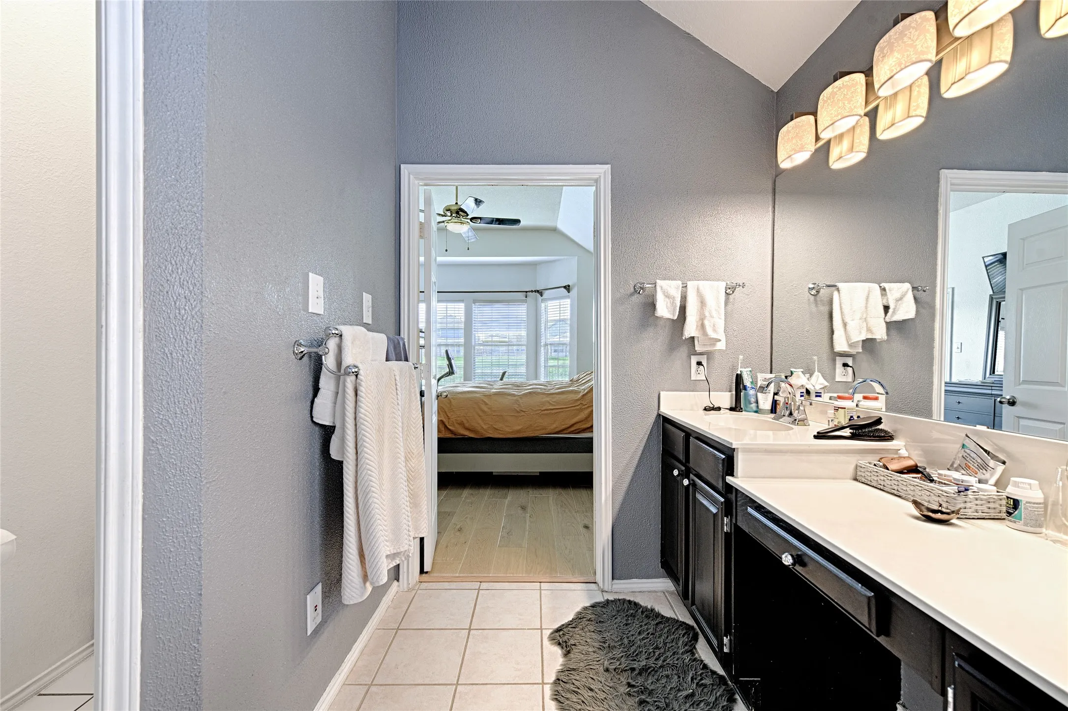 Dual vanity with white countertop and black cabinetry