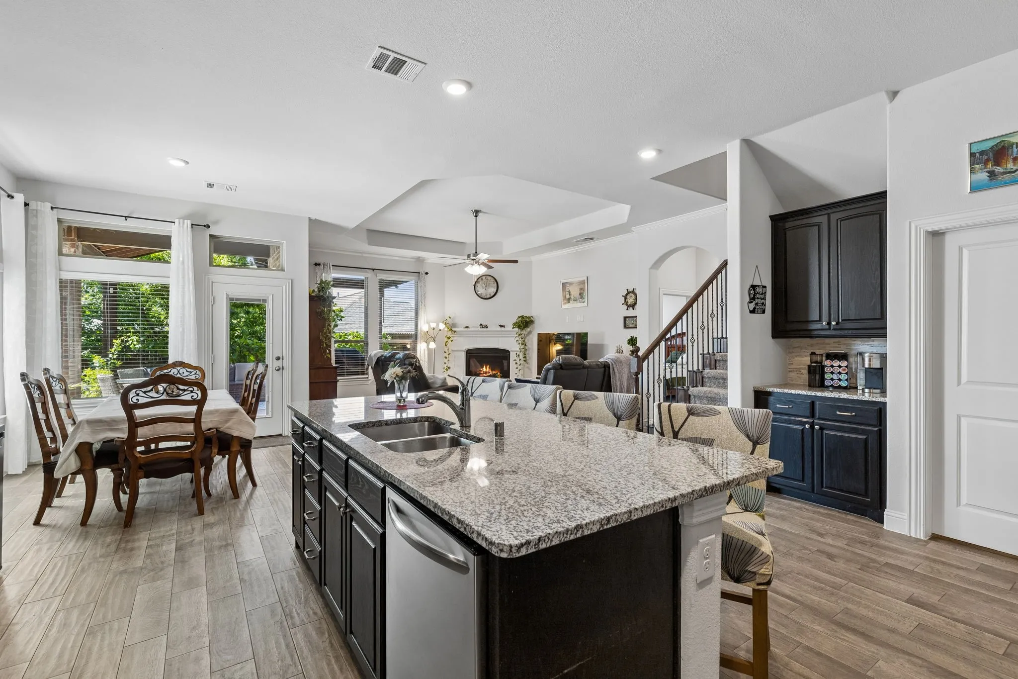 Life happens at this spacious kitchen island and breakfast bar. A great view of the coffee bar is also shown here!