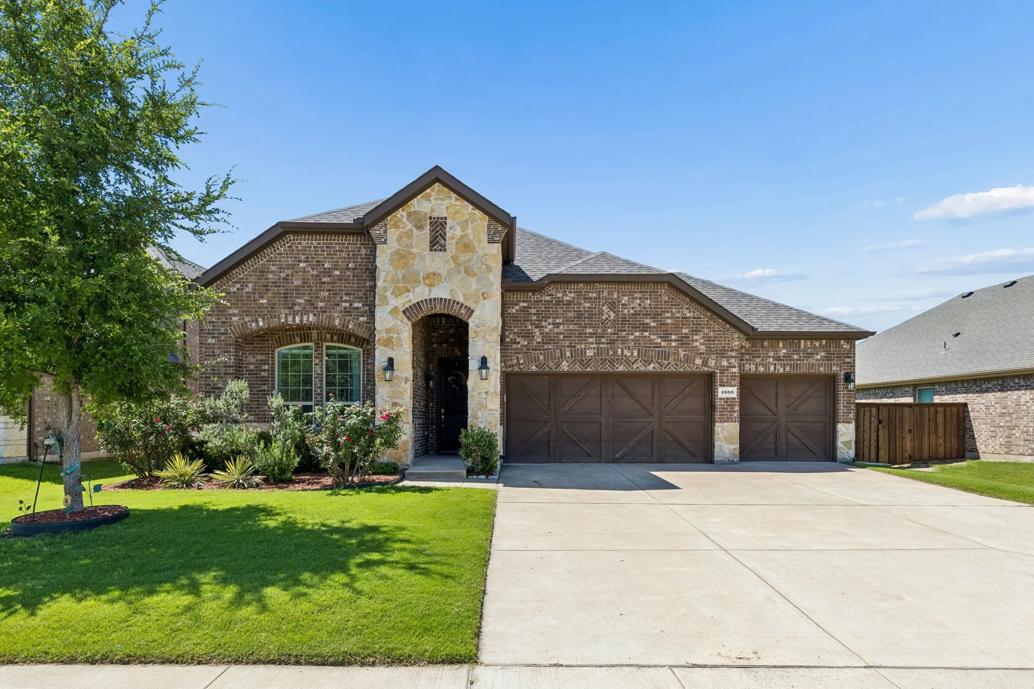 Traditional Brick and Stone Masonry with 3 Car Garage