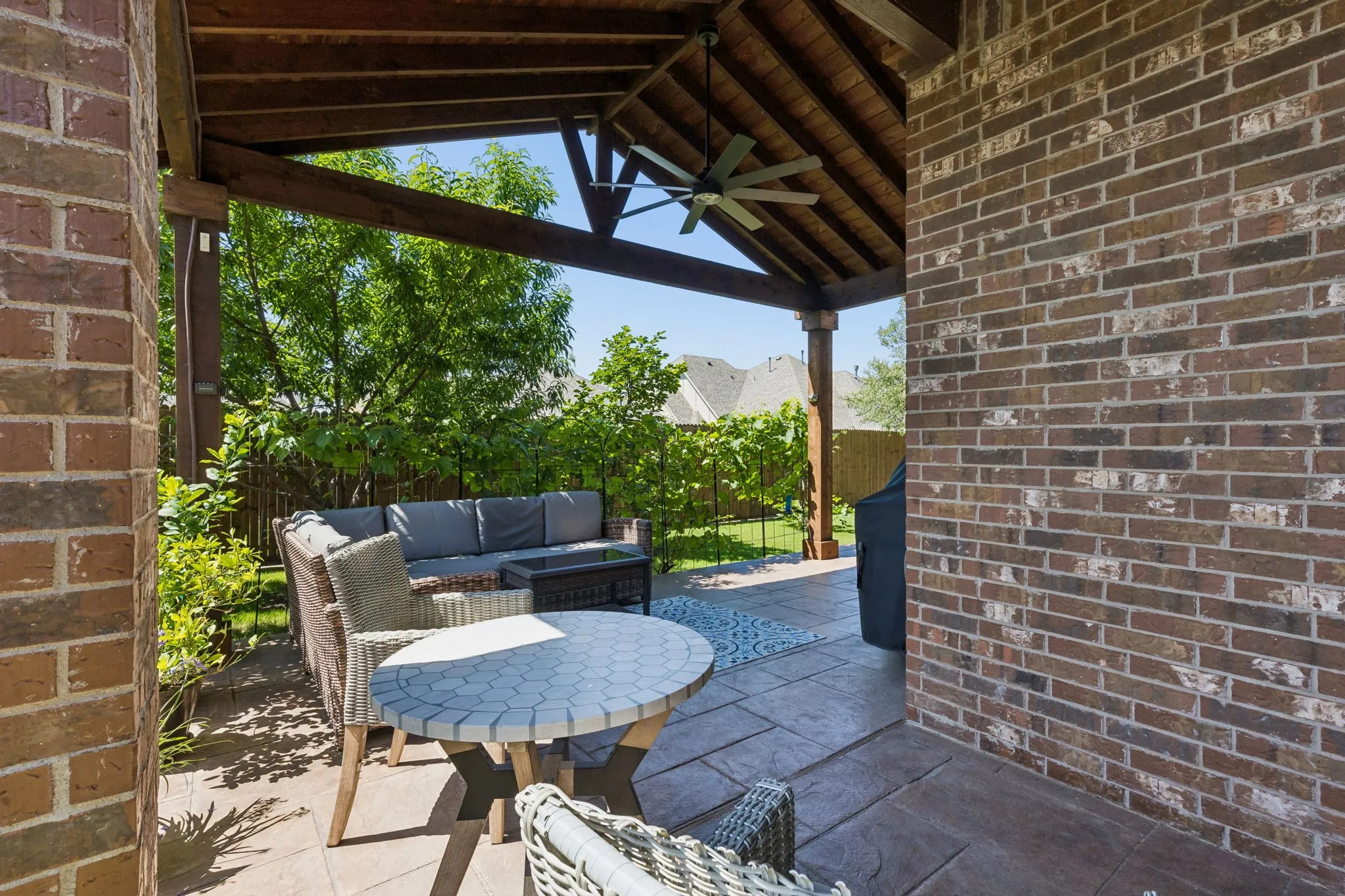 Peaceful covered patio with two kinds of Grapes that are growing along the patio that overlook 6 Different types of fruit trees!