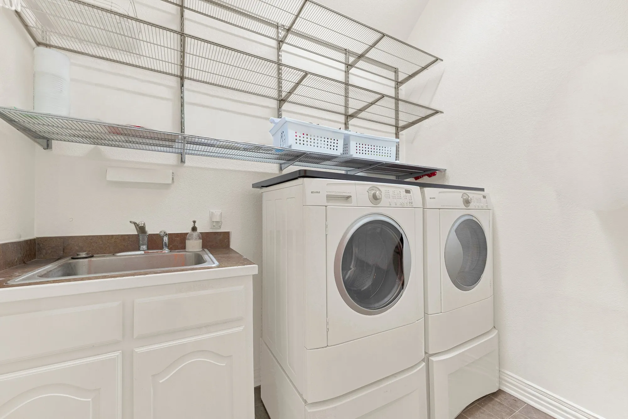 large laundry room with built-in shelves