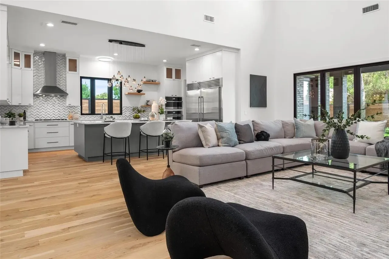 Open-concept living area featuring high ceilings and wood-finish flooring