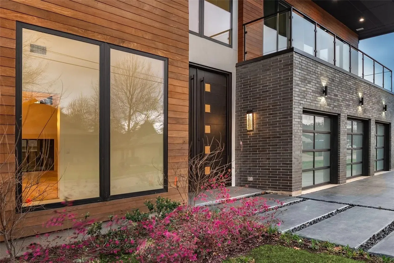 Modern exterior featuring wood-finish siding and dark brickwork