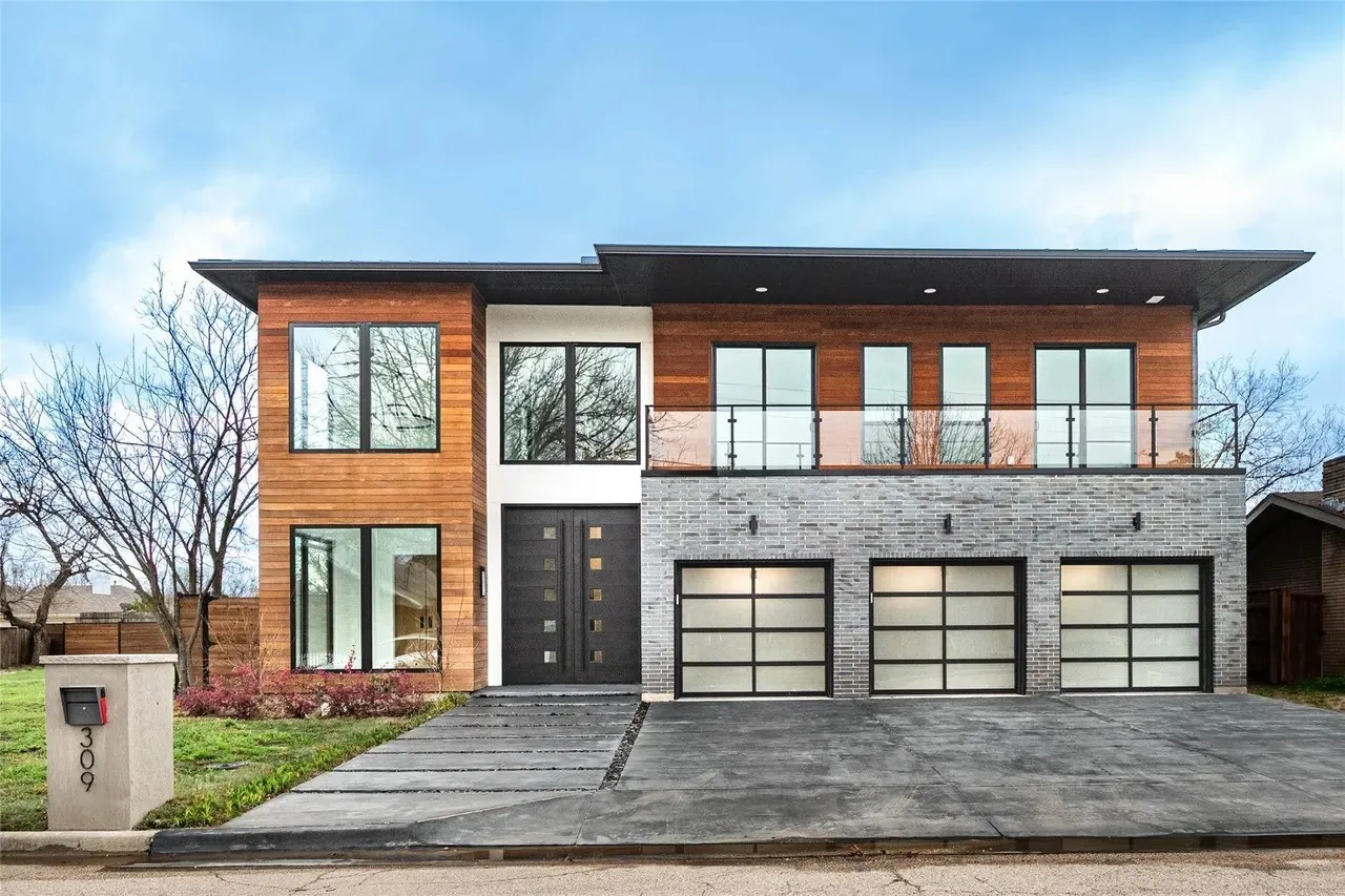 Contemporary exterior showcasing wood paneling, light gray brick, and large black-framed windows