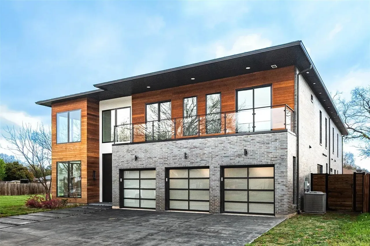 Modern multi-level exterior with wood paneling and grey brick accents