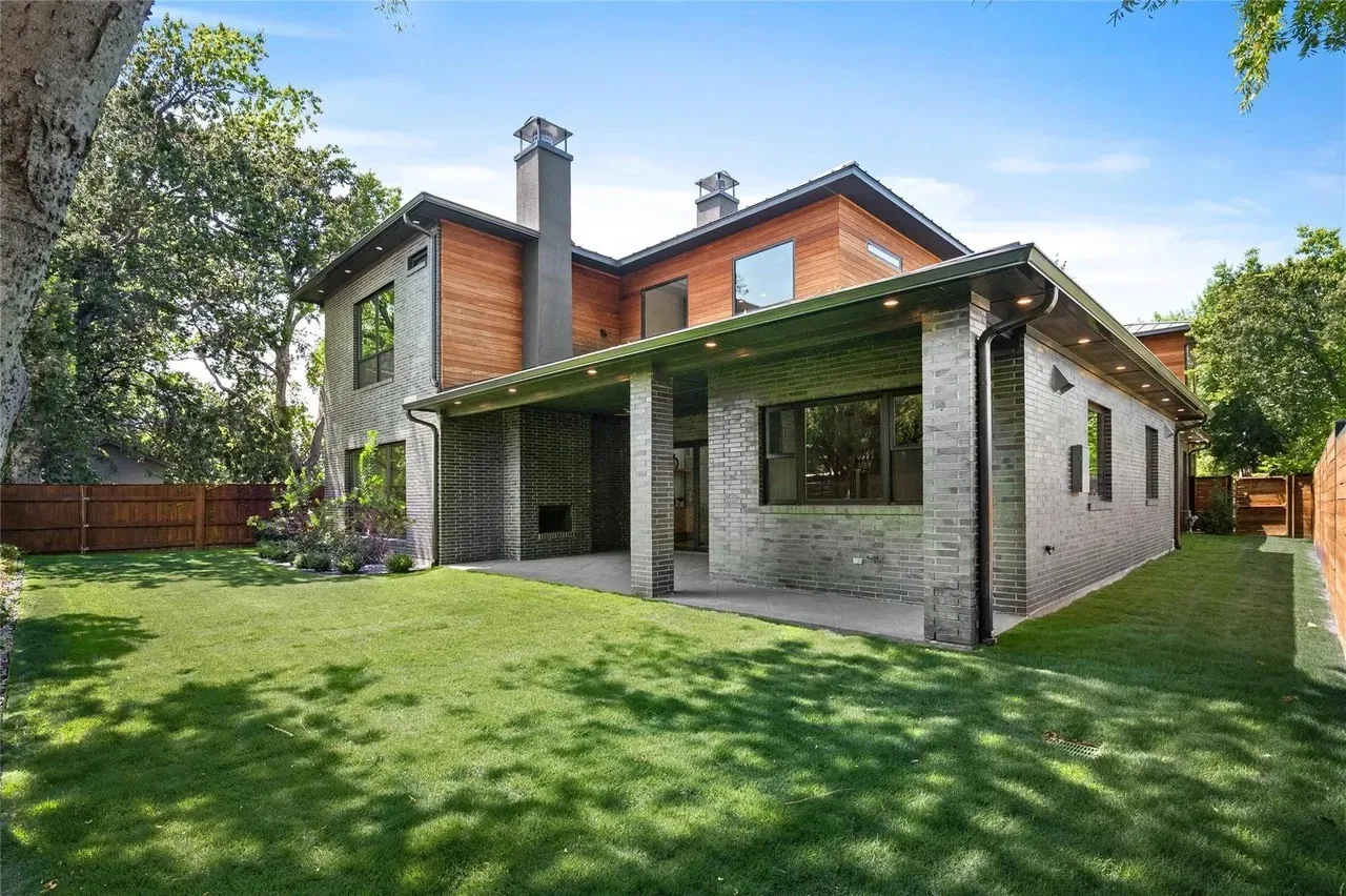 Contemporary rear exterior featuring multi-toned brick and wood-clad siding