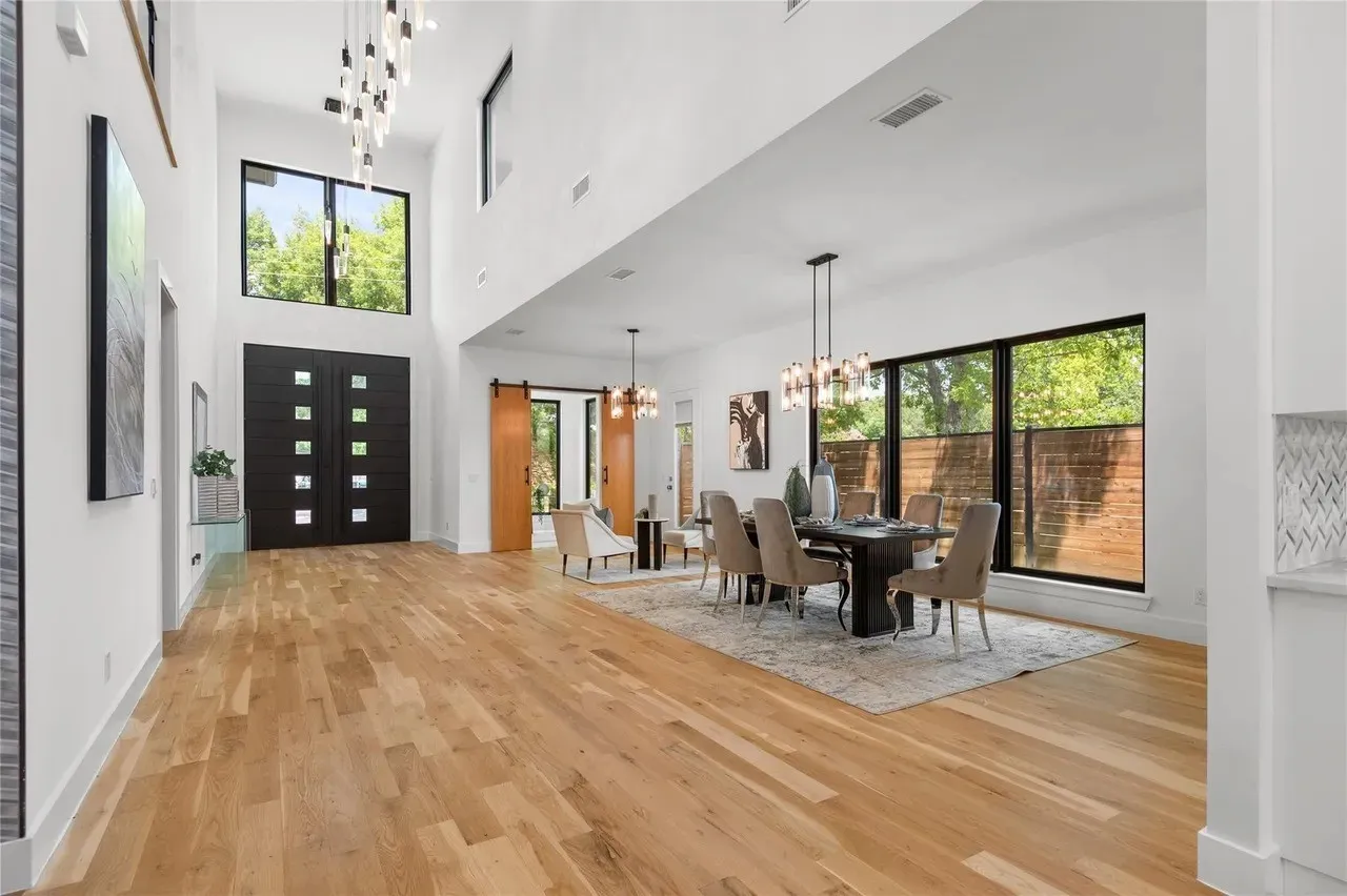 Grand entry featuring a double-height ceiling and light wood-finish flooring