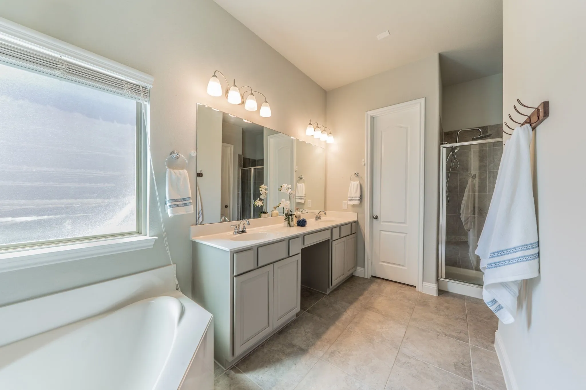Primary bath features a garden tub, a double vanity, separate shower and a large walk-in closet.