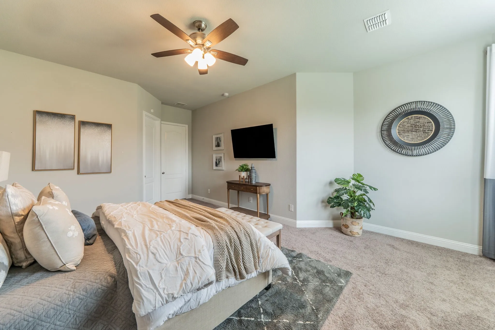 The primary suite is separate from the upstairs guest bedrooms for added privacy.
