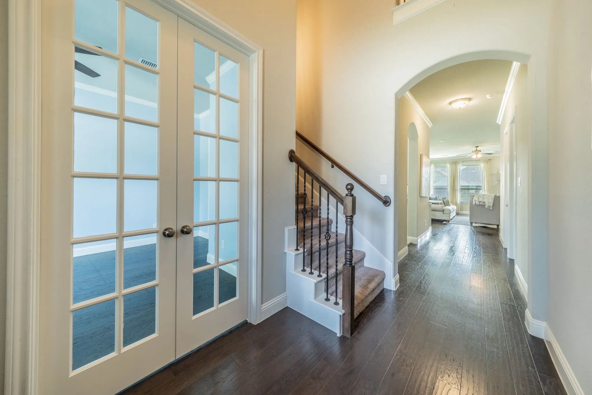 Enter to tall ceilings with French doors leading to the office.