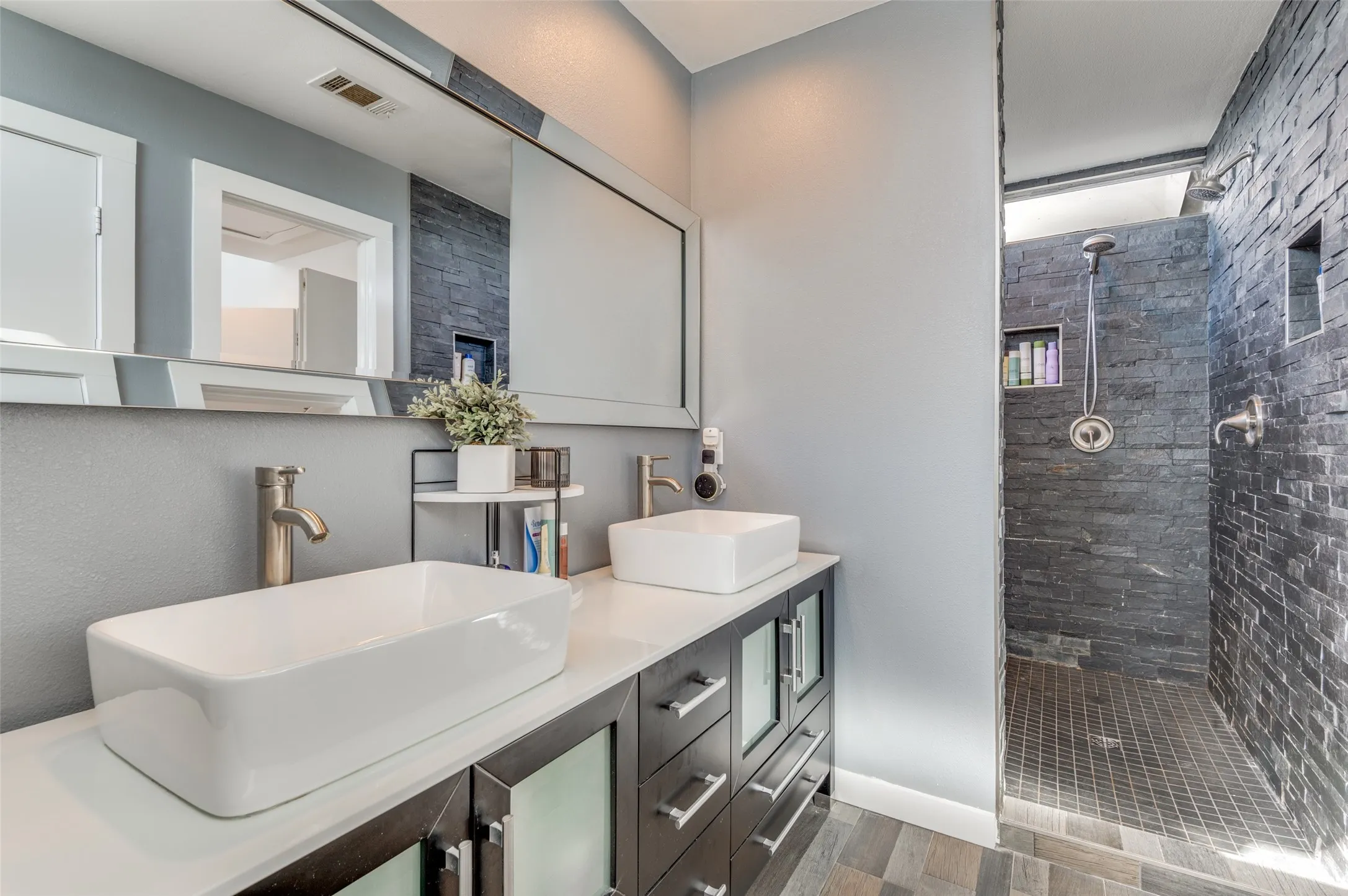 Renovated primary bath with dual sinks and an impressive wet room with soaking tub and shower