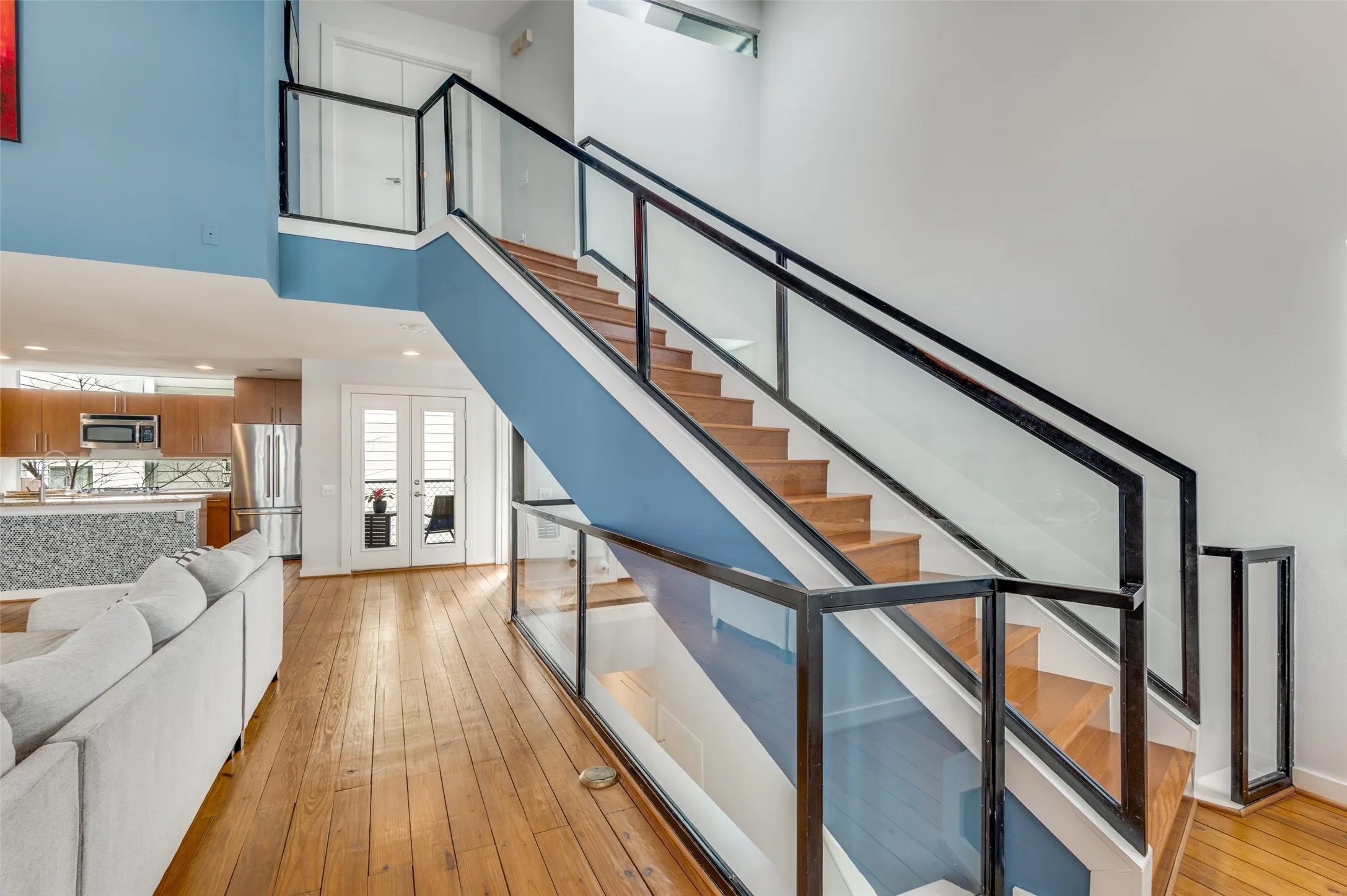 Striking floating staircase with glass bannisters and modern architectural design