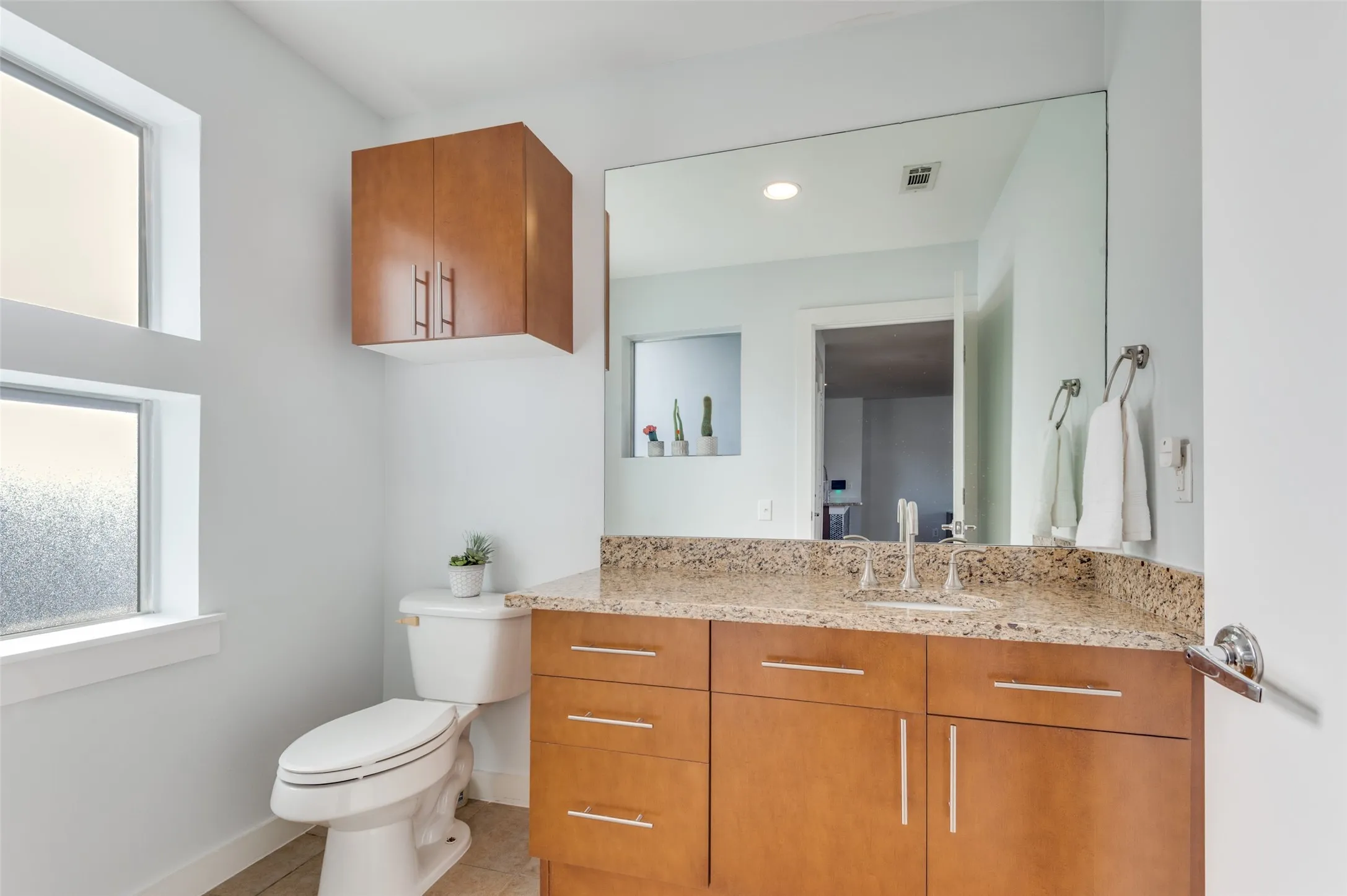 Convenient main level powder bath serving the second floor living and entertaining space