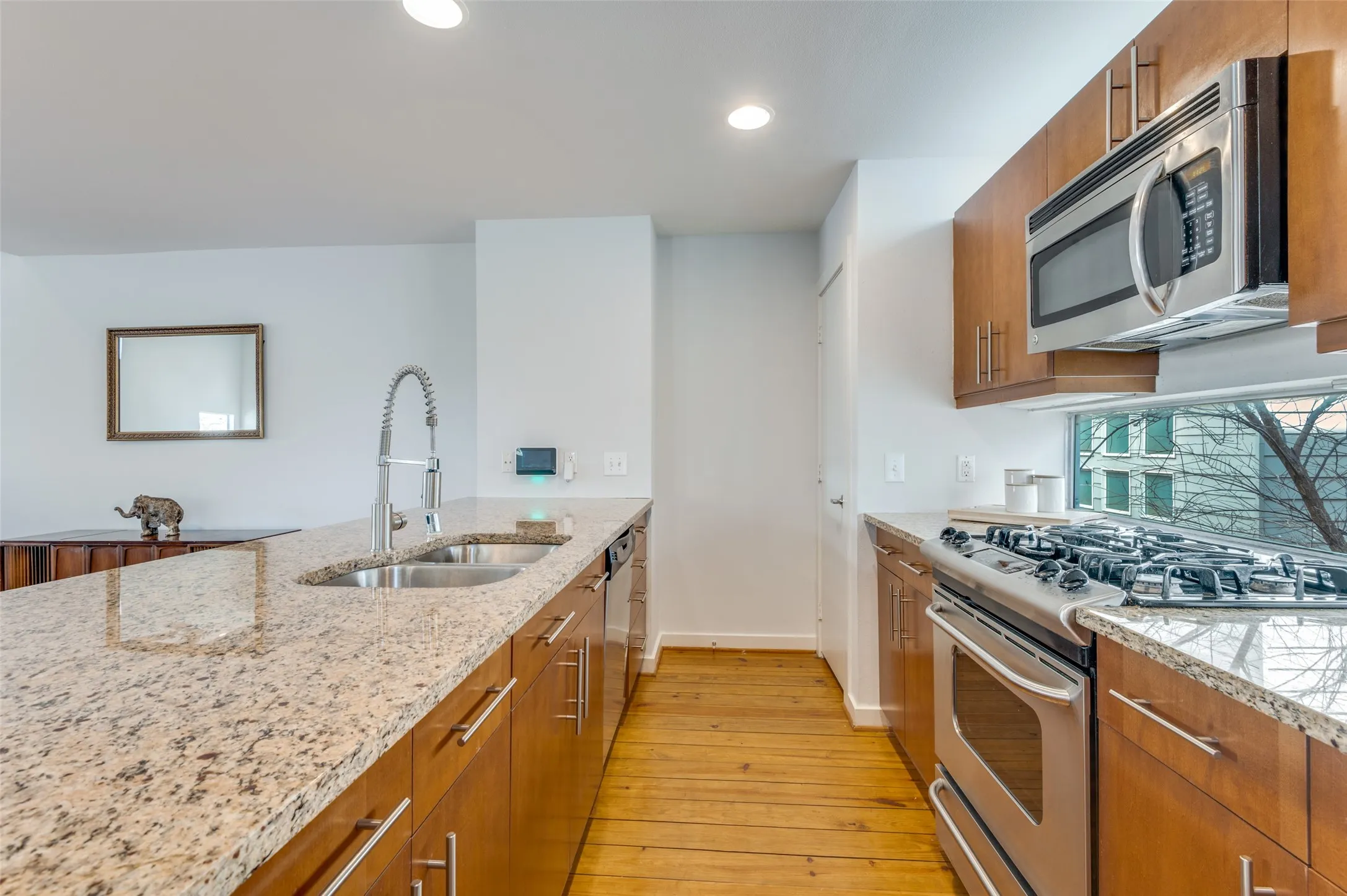 Chef’s kitchen with granite countertops, gas range, and breakfast bar seating