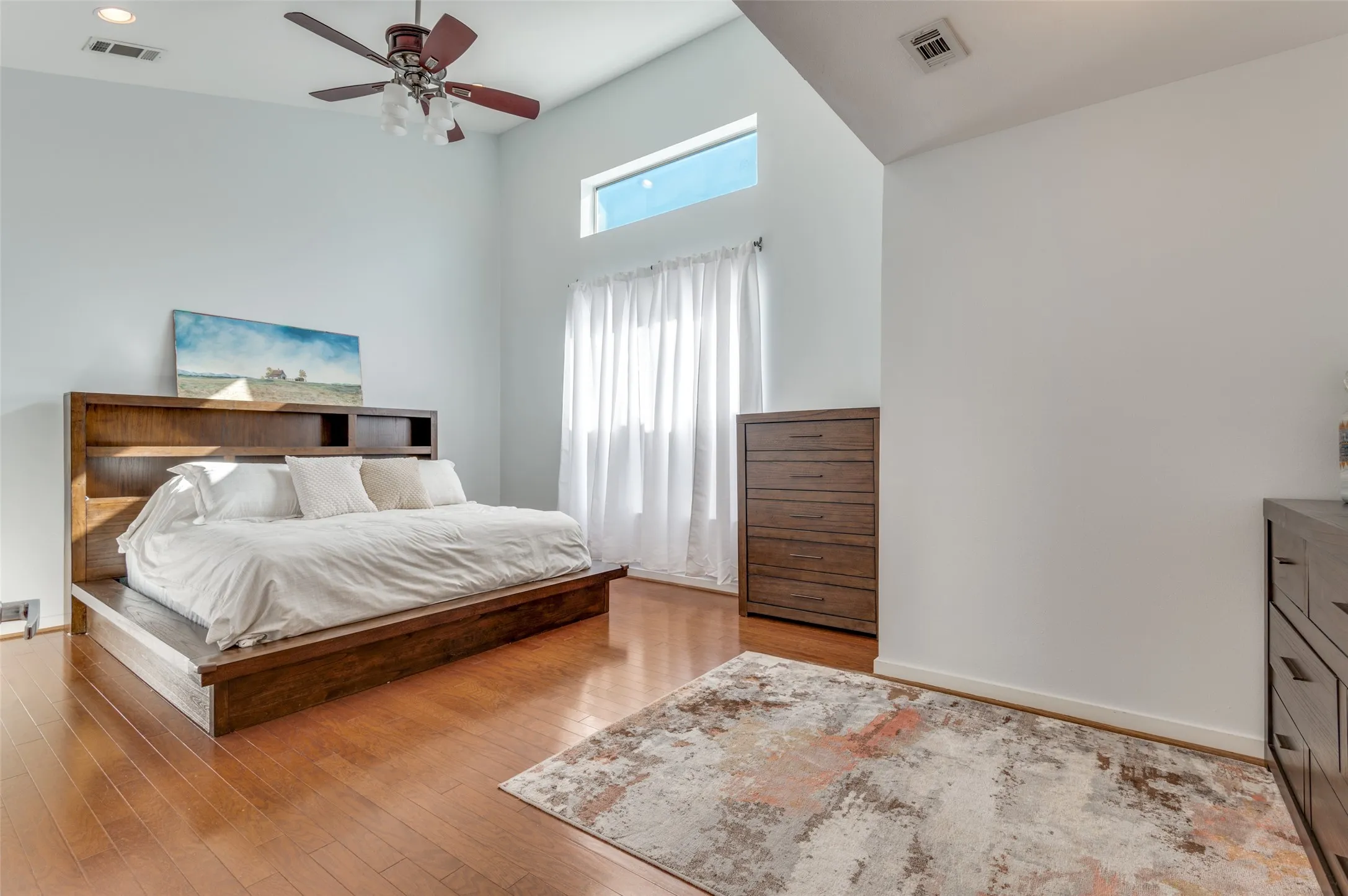 Primary suite featuring soaring ceilings, walk in closet, and spa inspired bath