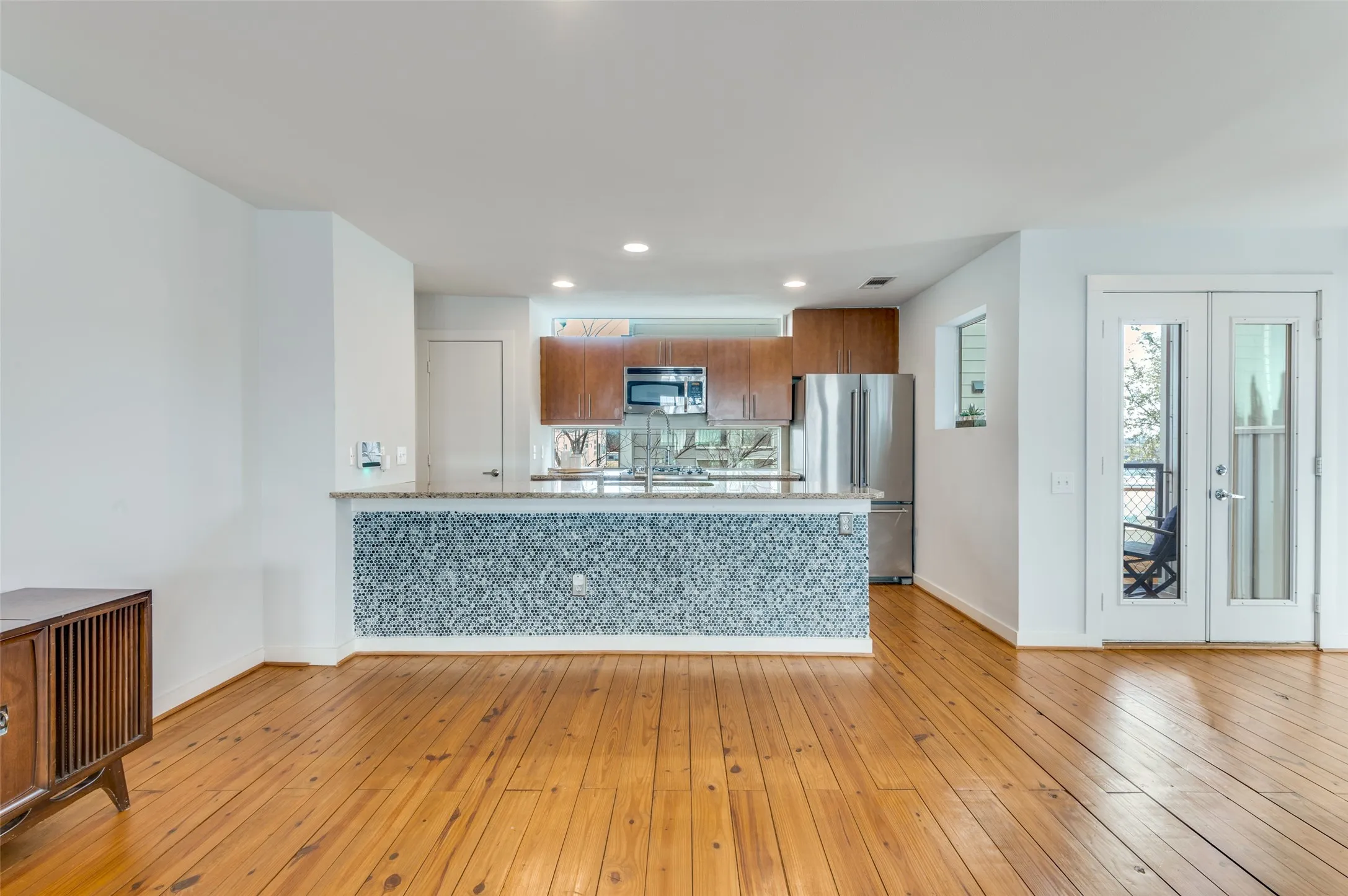 Chef’s kitchen with granite countertops, gas range, and breakfast bar seating